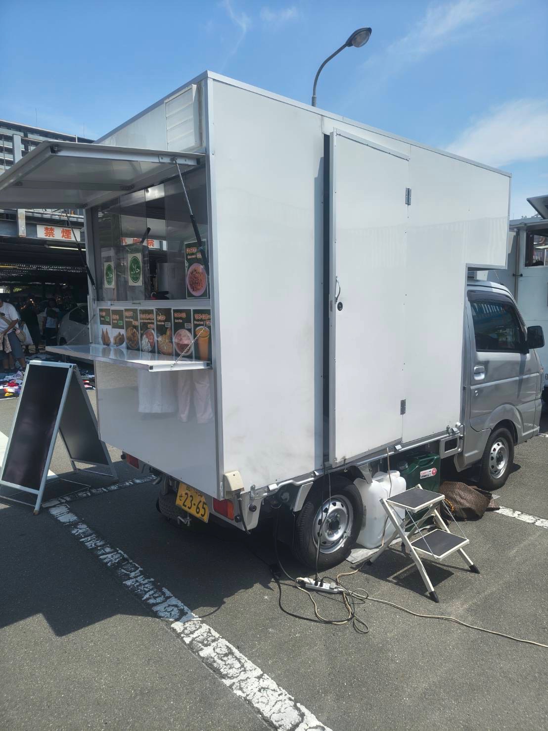 White box truck with the service window open and a drop-down shelf