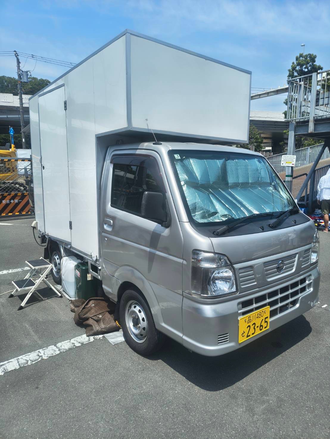 White Kei truck with the box built up and over the cab