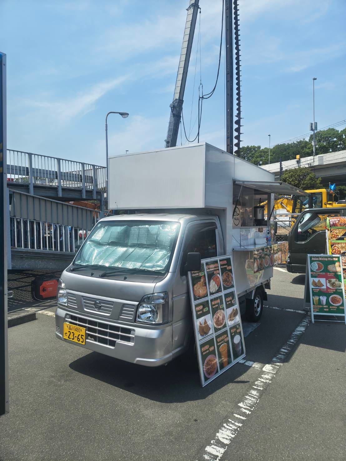 White Kei truck with the box built up and over the cab
