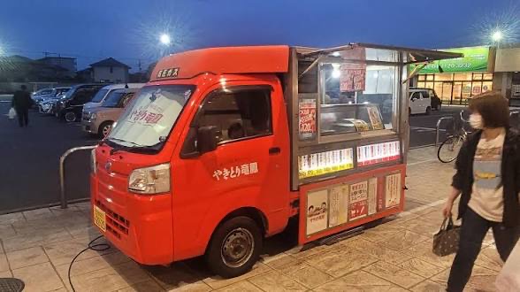 Red Kei truck yakitori cart lit up at night