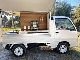 White Kei truck with a warm wood-lined service interior