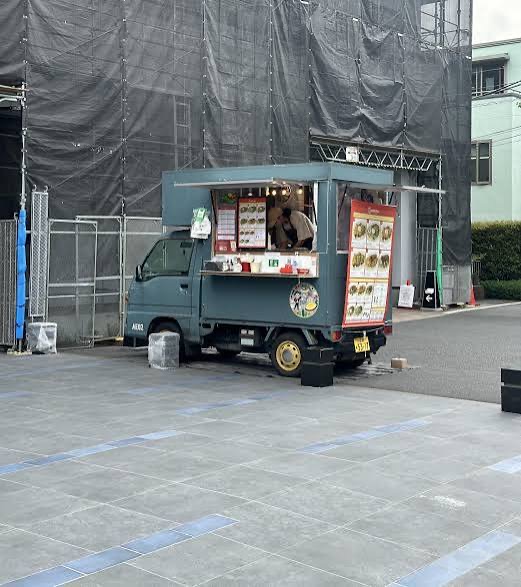 Slate blue Kei truck food cart parked on a job site